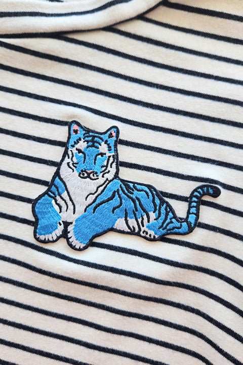 blue tiger embroidered patch on black and white stripe tee