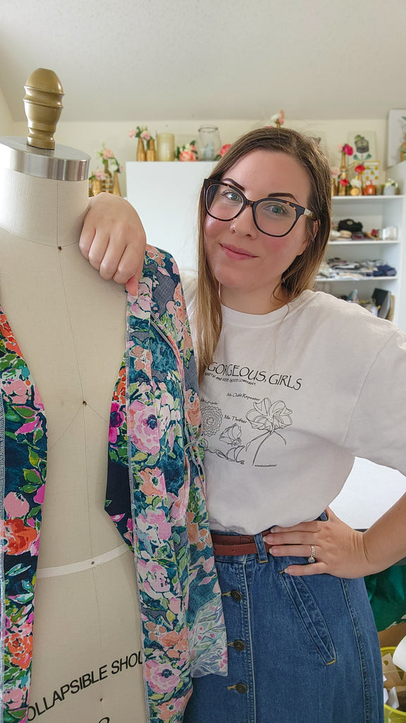 Image of the female owner of Lucky Franklin sustainable handmade clothing brand in her studio posing with a dress form