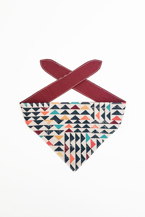 boho triangles print side of boho triangles reversible pet bandana. print features navy blue, red, orange, mustard, teal and cream colors.