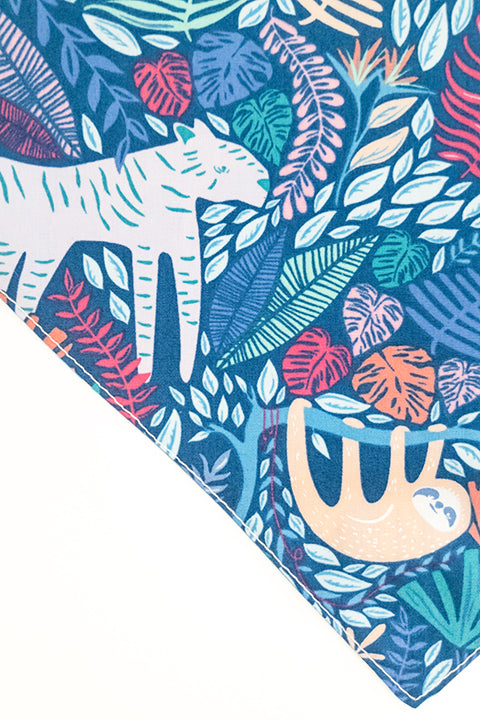 jungle animals print side zoomed in detail of jungle friends reversible pet bandana. prints feature jungle animals, plants and tigers on blue backgrounds.