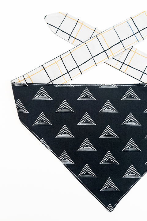 black and white pyramids print side detailed viewof pyramids and grid reversible pet bandana. prints feature black, white, yellow and blue.