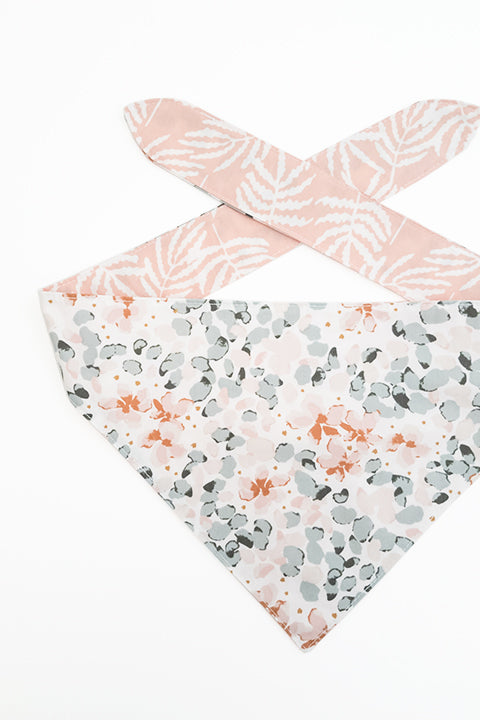 watercolor floral detailed view of watercolor ferns reversible pet bandana. prints feature pastel shades of pink and green.