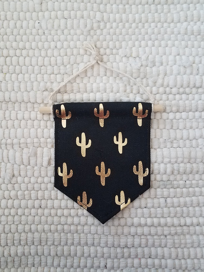 mini handmade pennant ornament featuring a black cotton canvas fabric printed with gold cactus