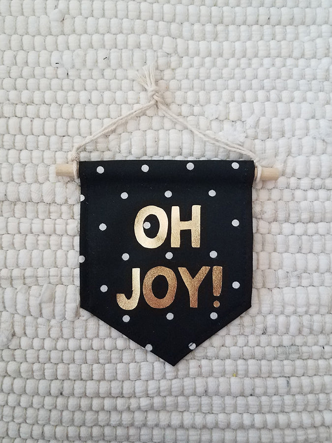 mini handmade pennant ornament featuring black with white dots fabric printed with Oh Joy in gold