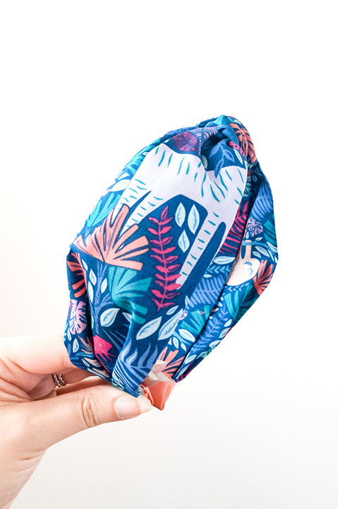 side view of an upcycled cotton fabric headband featuring a top knot and tropical jungle friends animal print fabric