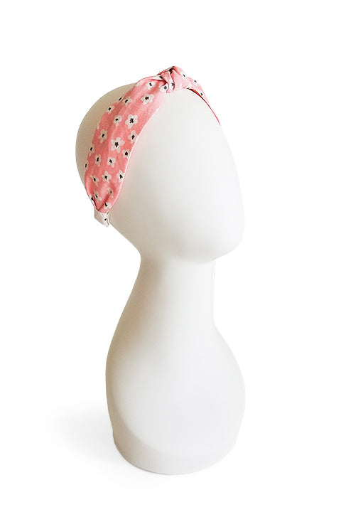 upcycled handmade headband made from a 100% cotton fabric scraps in a lucky floral print with pink, cream and black. shown on a white model form
