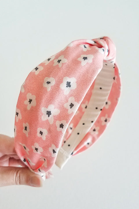 side view upcycled handmade headband made from a 100% cotton fabric scraps in a lucky floral print with pink, cream and black.