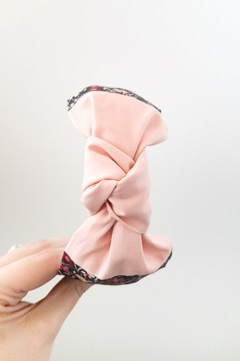 top know view of a lucky franklin headband handmade using upcycled 100% premium cotton fabric scraps with a tiny floral print and blush pink solid