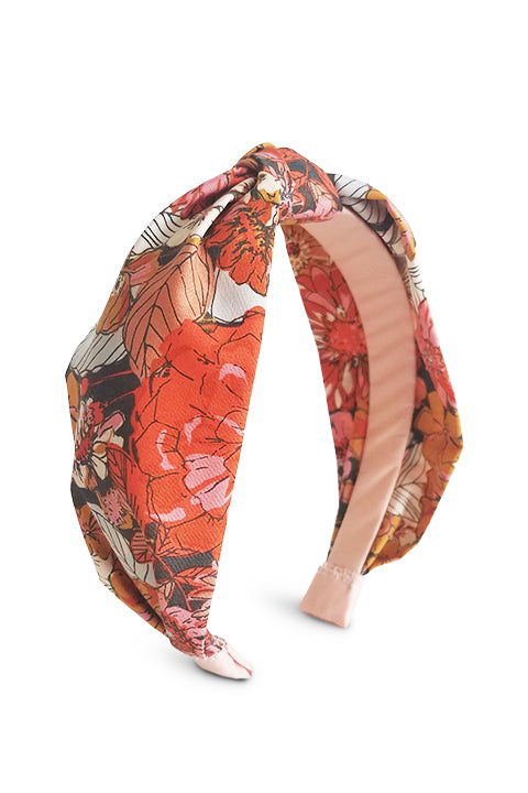 Image of an upcycled and sustainable handmade headband made from 100 percent premium cotton fabric waste in the rustic blooms print which features large floral bloom in hues of rust, orange and brown