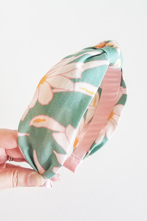 side view of upcycled handmade headband made from a 100% cotton fabric scraps in a verdant floral print with green, cream, pink and mustard.
