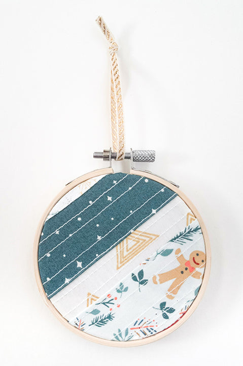3 inch diameter wooden embroidery hoop ornament crafted from quilted scrap fabric in holiday and christmas prints - diagonal stripes 1