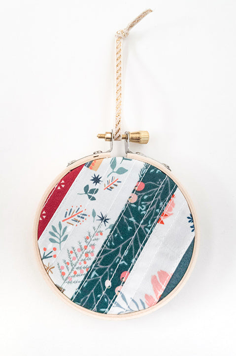 3 inch diameter wooden embroidery hoop ornament crafted from quilted scrap fabric in holiday and christmas prints - diagonal stripes 3