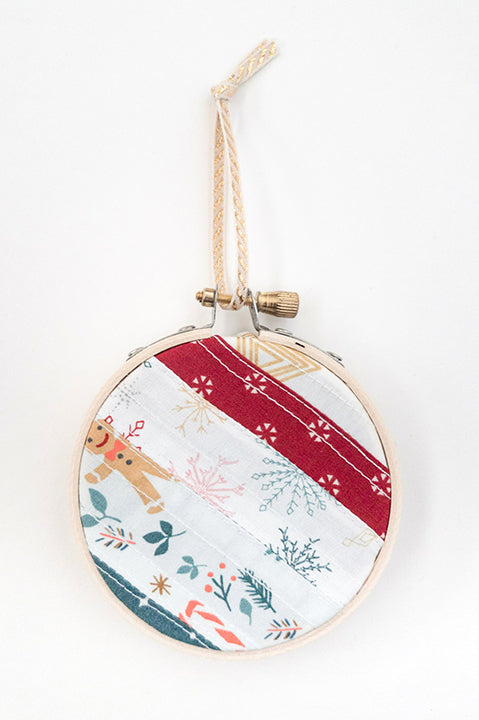 3 inch diameter wooden embroidery hoop ornament crafted from quilted scrap fabric in holiday and christmas prints - diagonal stripes 6
