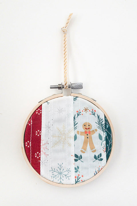 3 inch diameter wooden embroidery hoop ornament crafted from quilted scrap fabric in holiday and christmas prints - vertical stripes 3