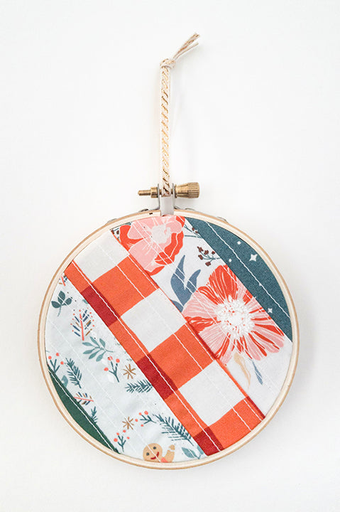 4 inch diameter wooden embroidery hoop ornament crafted from quilted scrap fabric in holiday and christmas prints - diagonal stripes 1