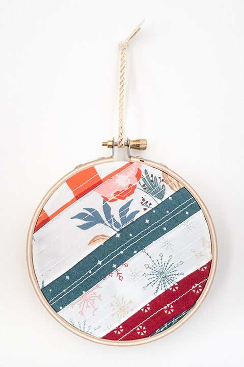 4 inch diameter wooden embroidery hoop ornament crafted from quilted scrap fabric in holiday and christmas prints - diagonal stripes 2