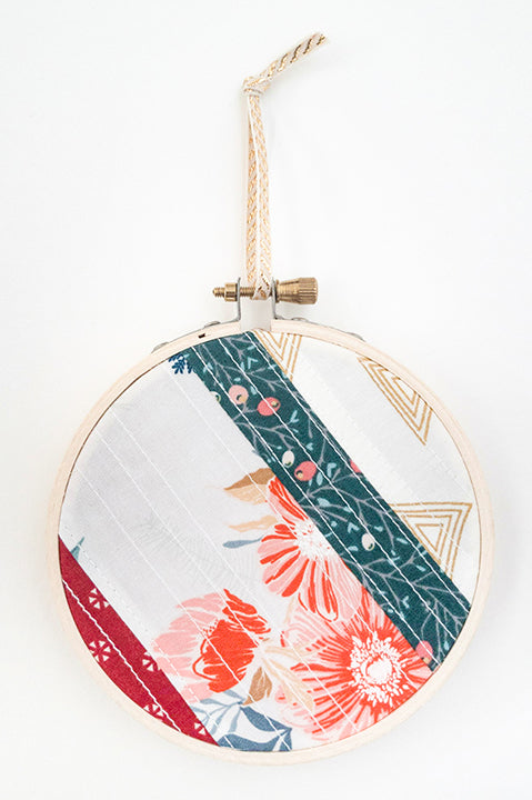 4 inch diameter wooden embroidery hoop ornament crafted from quilted scrap fabric in holiday and christmas prints - diagonal stripes 5