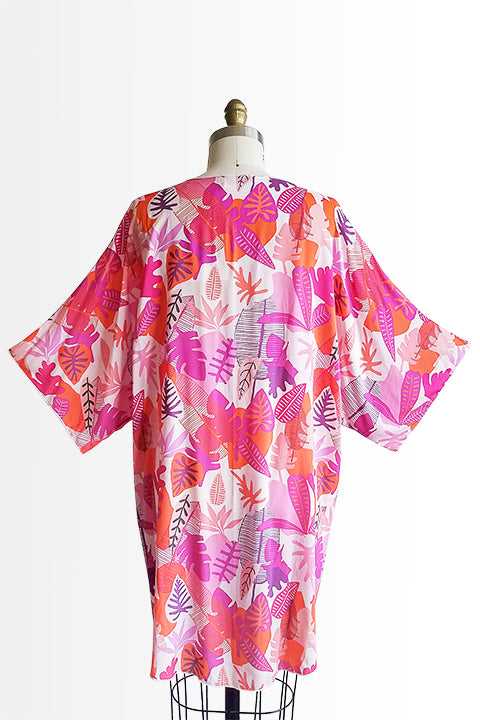 back view of small batch open front fashion kimono made from a 100% rayon hot pink tropical leaf print fabric shown on a dress form