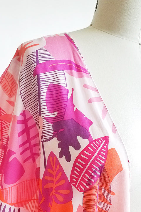 fabric detail view small batch open front fashion kimono made from a 100% rayon hot pink tropical leaf print fabric shown on a dress form