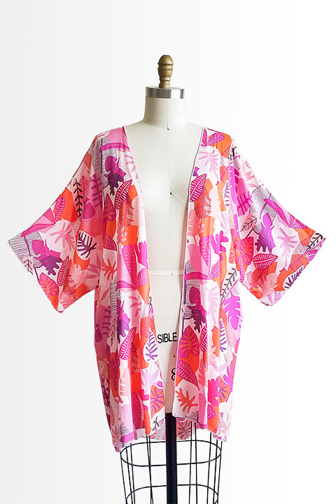 front view of small batch open front fashion kimono made from a 100% rayon hot pink tropical leaf print fabric shown on a dress form
