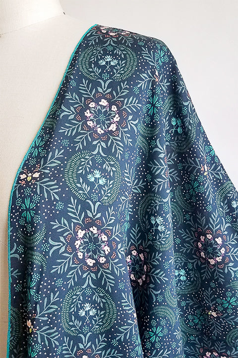neckline detail view of small batch open front fashion kimono made from a 100% rayon midnight blue fabric printed with fireflies and a pink and green floral motif shown on a dress form
