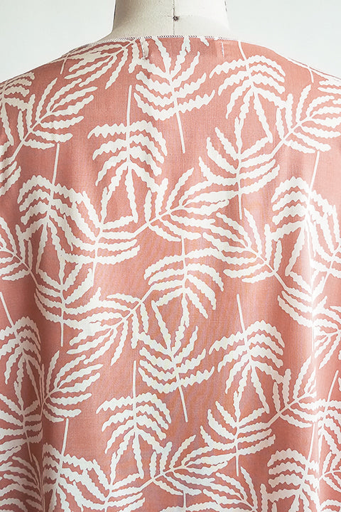 back neck detail view of small batch open front fashion kimono made from a 100% rayon cinnamon pink fabric printed with white fern leaves shown on a dress form