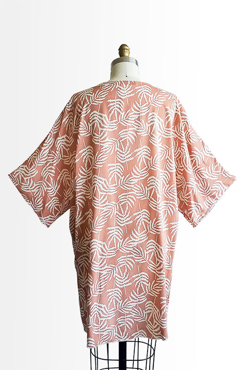 back view of small batch open front fashion kimono made from a 100% rayon cinnamon pink fabric printed with white fern leaves shown on a dress form
