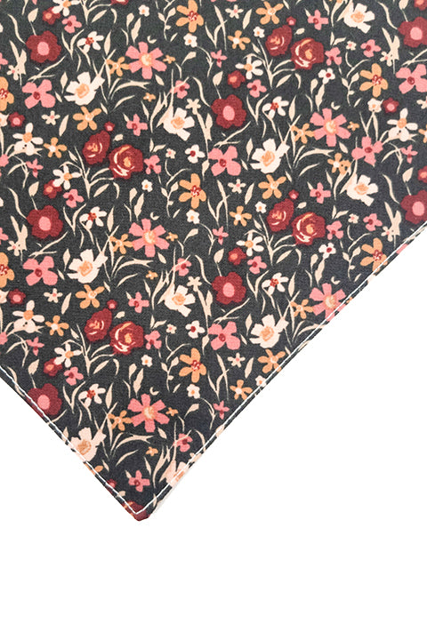zoomed in view of the pink and black mini floral print on the reversible pet bandana