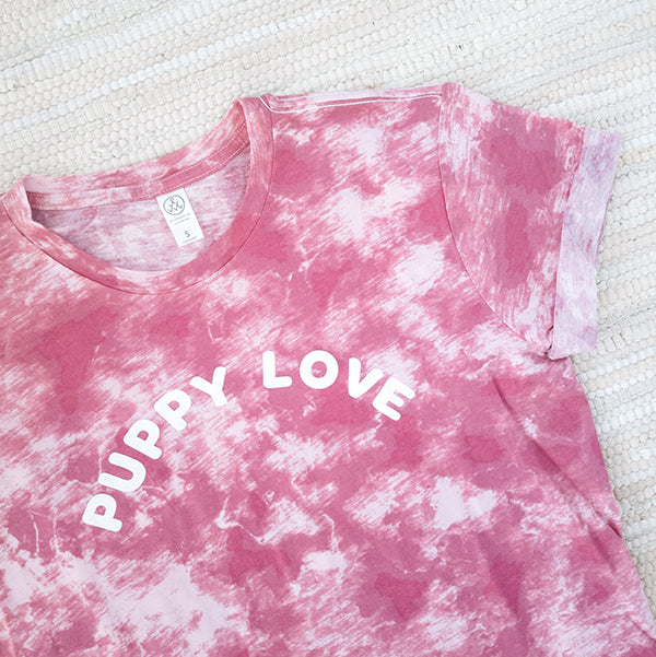 cropped detail image of puppy love arched font on a pink tie-dye Alternative cotton tee