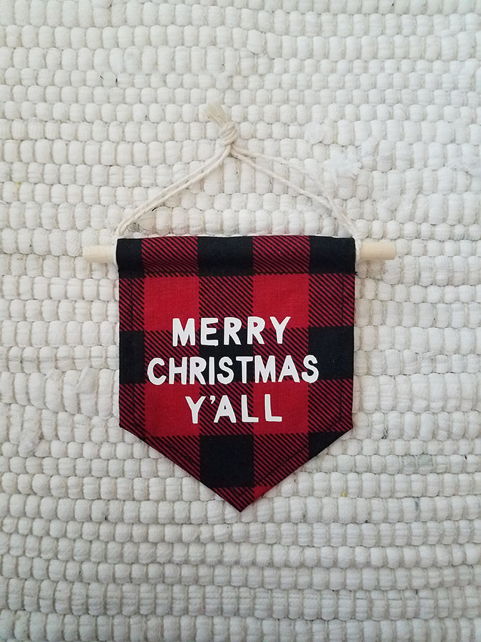 mini handmade pennant ornament featuring a black and red buffalo plaid fabric and printed with Merry Christmas Y'all in white