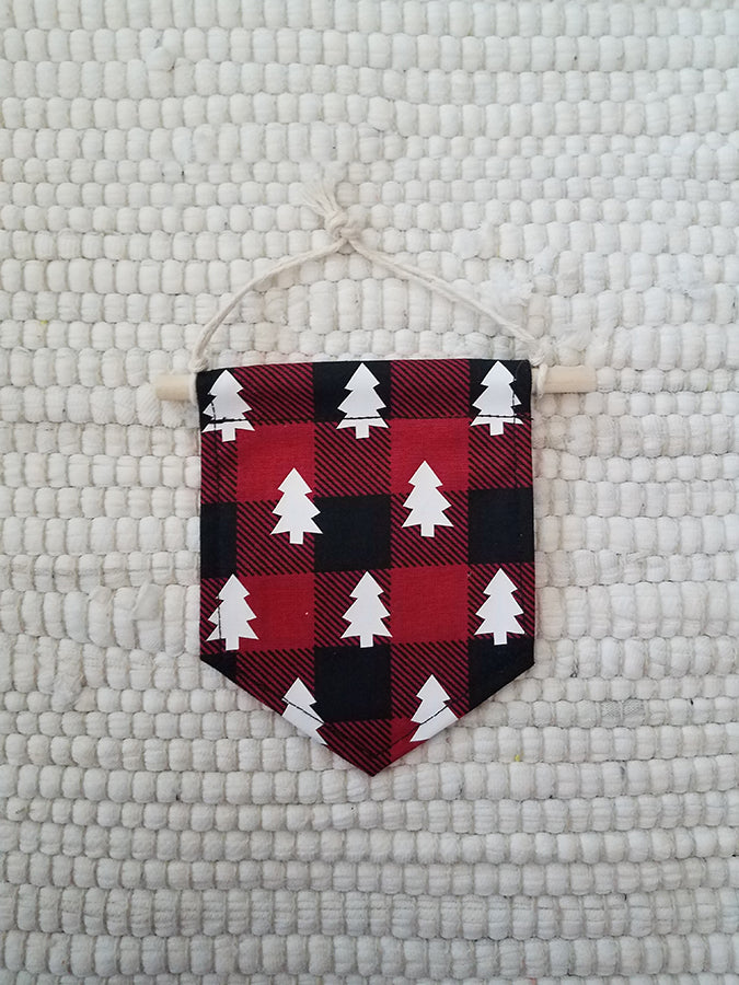 mini handmade pennant ornament featuring a black and red buffalo plaid printed with white pine trees